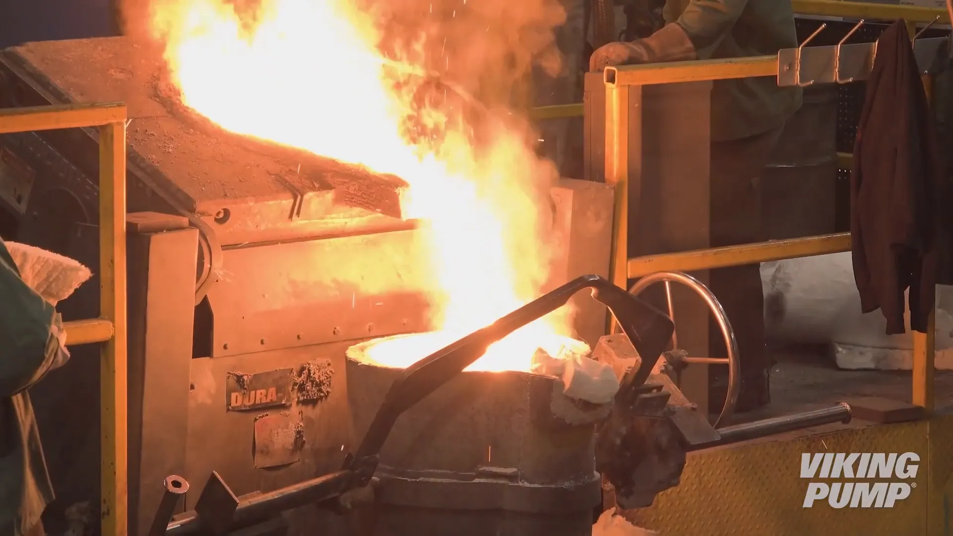 Molten metal being poured into a foundry ladle