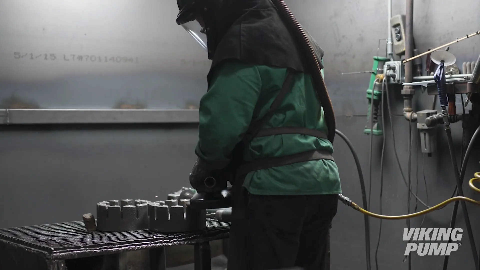A worker grinding off excess metal on some rotors